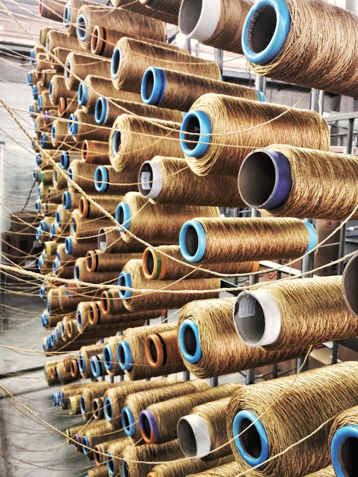 Rows of sewing thread spools in a São Paulo factory assembly line.